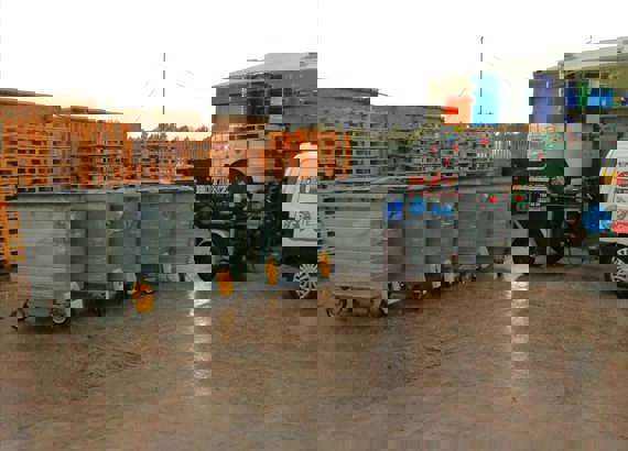 Four large grey commercial bins 